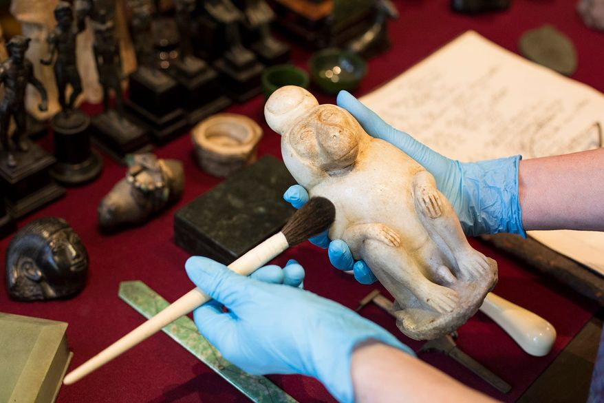 Baboon of Thoth in the hands of conservator | museum photography | © Freud Museum London